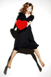 Businesswoman holding a red heart.