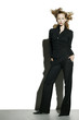 Businesswoman being blown by strong wind.