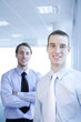 Businessmen smiling at the camera.