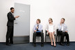 Business people waiting for their turn to be interviewed.