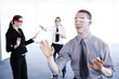 Blindfolded business people finding their ways.