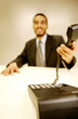 Businessman picking up a phone call.