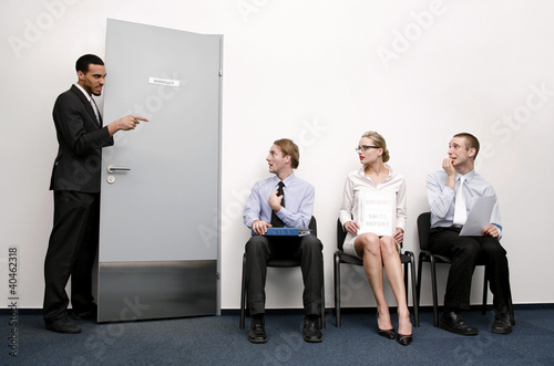 Foto: Business people waiting for their turn to be interviewed. Business people waiting for their turn to be interviewed.