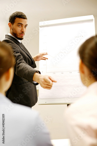 Photo: Businessman giving presentation in the conference room. Businessman giving presentation in the conference room.