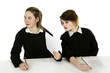 Girl showing her answers to her classmate.