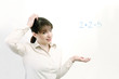 Photo: Woman having problem solving a simple equation. Woman having problem solving a simple equation.
