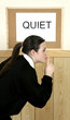Girl showing hushing sign.
