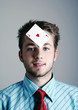 Businessman with a playing card on his forehead.