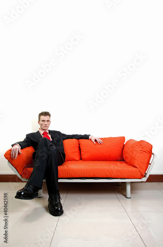 Photo: Businessman sitting on the couch with his legs crossed. Businessman sitting on the couch with his legs crossed.
