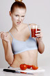 Woman holding a glass of tomato juice.