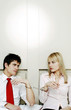 Businessman and businesswoman being handcuffed together.