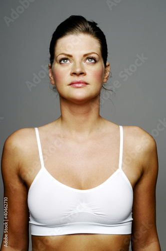 Photo: Woman in sport clothing looking up. Woman in sport clothing looking up.