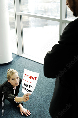 Photo: Businesswoman submitting an urgent sales report. Businesswoman submitting an urgent sales report.