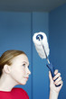 Woman holding a paint roller.