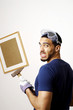 Man with goggles holding a hammer.