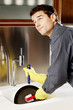 Photo: Man cleaning a frying pan. Man cleaning a frying pan.