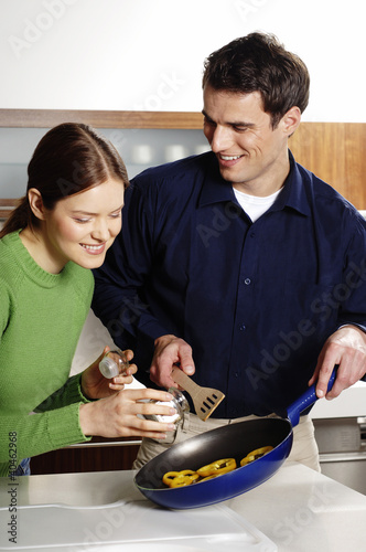 Photo: Couple cooking in the kitchen. Couple cooking in the kitchen.