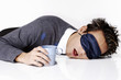 Photo: Man with eye mask sleeping with the head on the table. Man with eye mask sleeping with the head on the table.