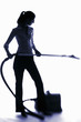 Photo: Businesswoman using vacuum cleaner. Businesswoman using vacuum cleaner.