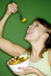 Woman enjoying a bowl of salad.