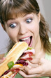 Woman eating baguette.