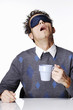 Photo: Man with eye mask holding a cup of coffee. Man with eye mask holding a cup of coffee.