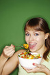 Woman enjoying a bowl of salad.