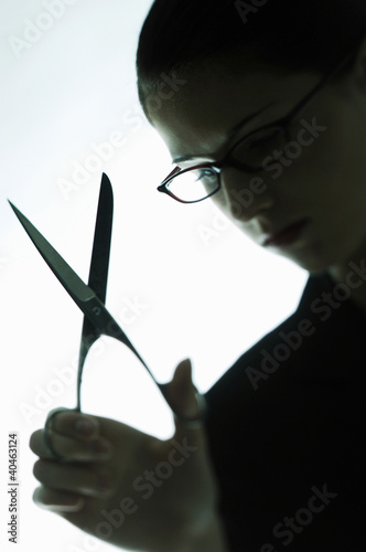 Photo: Businesswoman holding a scissors. Businesswoman holding a scissors.