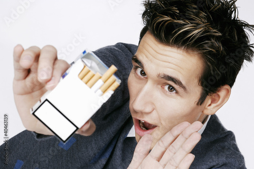 Photo: Man saying no to a box of cigarette. Man saying no to a box of cigarette.