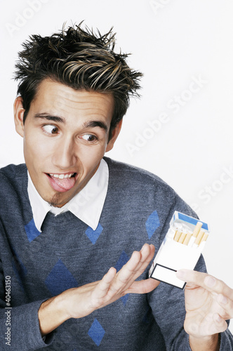 Photo: Man saying no to a box of cigarette. Man saying no to a box of cigarette.