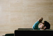 Foto: Man sitting on the couch thinking. Man sitting on the couch thinking.
