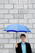 Businessman holding an umbrella.
