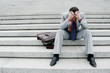 Depressed businessman sitting on the stairs.