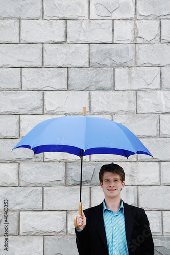 Photo: Businessman holding an umbrella. Businessman holding an umbrella.
