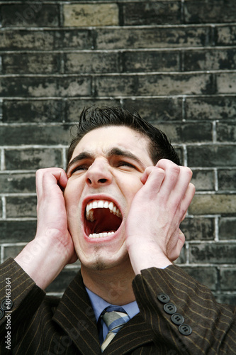 Photo: Stressed out businessman screaming. Stressed out businessman screaming.