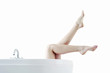 Photo: Legs coming out from a bathtub Legs coming out from a bathtub