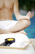 Man meditating by the pool side