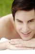 Man lying forward on the massage table smiling