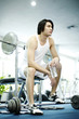 Man sitting in gym holding a bottled water