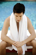 Man sitting on massage table with his eyes closed