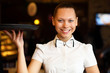 Portrait of young waitress holding a tray