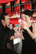 Couple proposing a toast while drinking in a bar