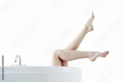 Photo: Legs coming out from a bathtub Legs coming out from a bathtub