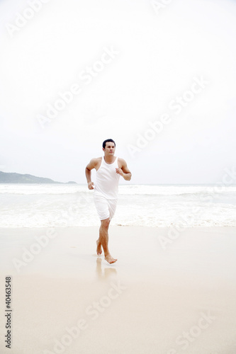 Photo: Man running on the beach Man running on the beach
