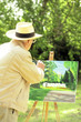 Photo: Senior man painting in the park Senior man painting in the park