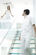 Woman looking at her boyfriend walking down the staircase