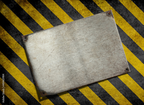 Photo: old metal plate background with hazard stripes old metal plate background with hazard stripes