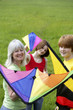 Woman and her children holding kites