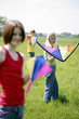 Woman and her children holding kites
