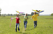 Woman and her children flying kites